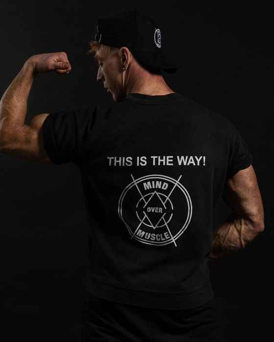 Vincent van Haren van achteren in een Mind Over Muscle-shirt met de tekst This is the way